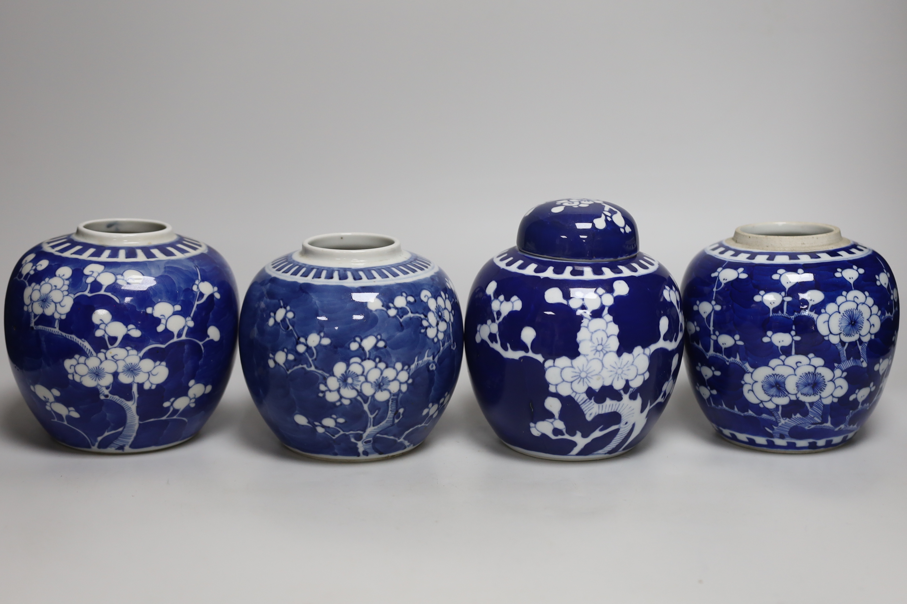 Five Chinese blue and white prunus ginger jars, one with cover- 15cm high and another jar